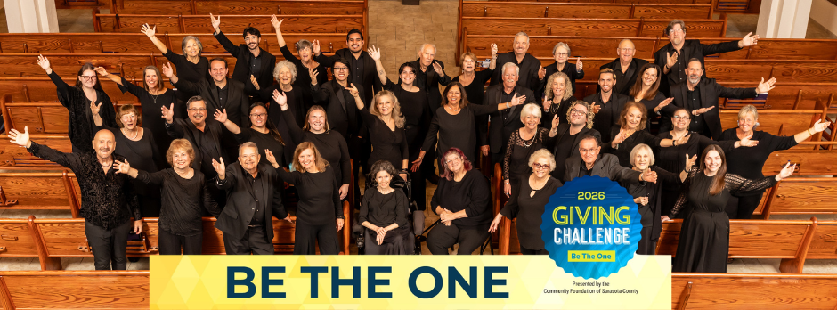 Large group of choir members dressed in black standing in church pews with arms raised, promoting the 2026 Giving Challenge with the message “Be The One.”